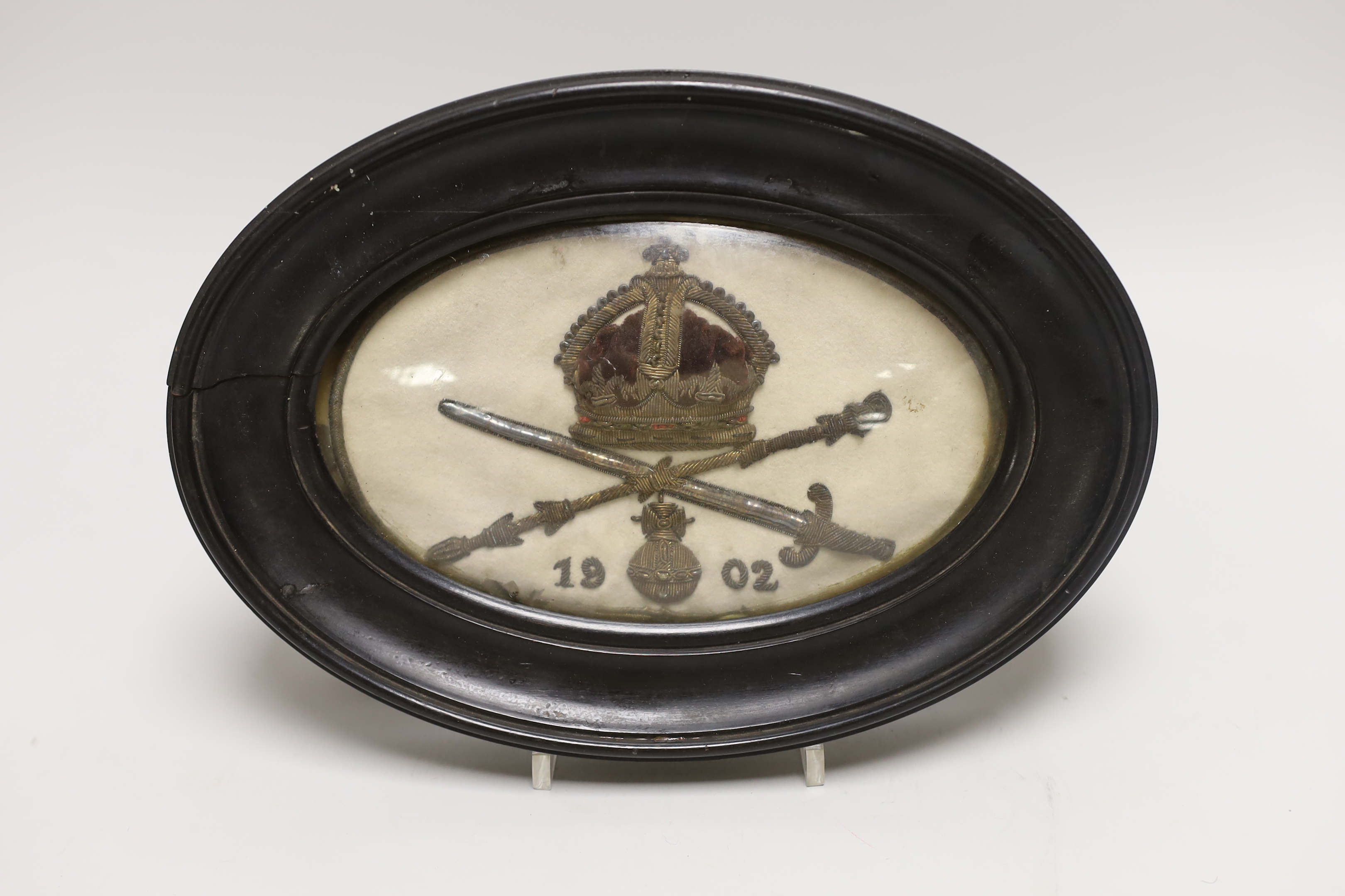 A framed 1902 Regimental embroidery, 27cm wide including frame